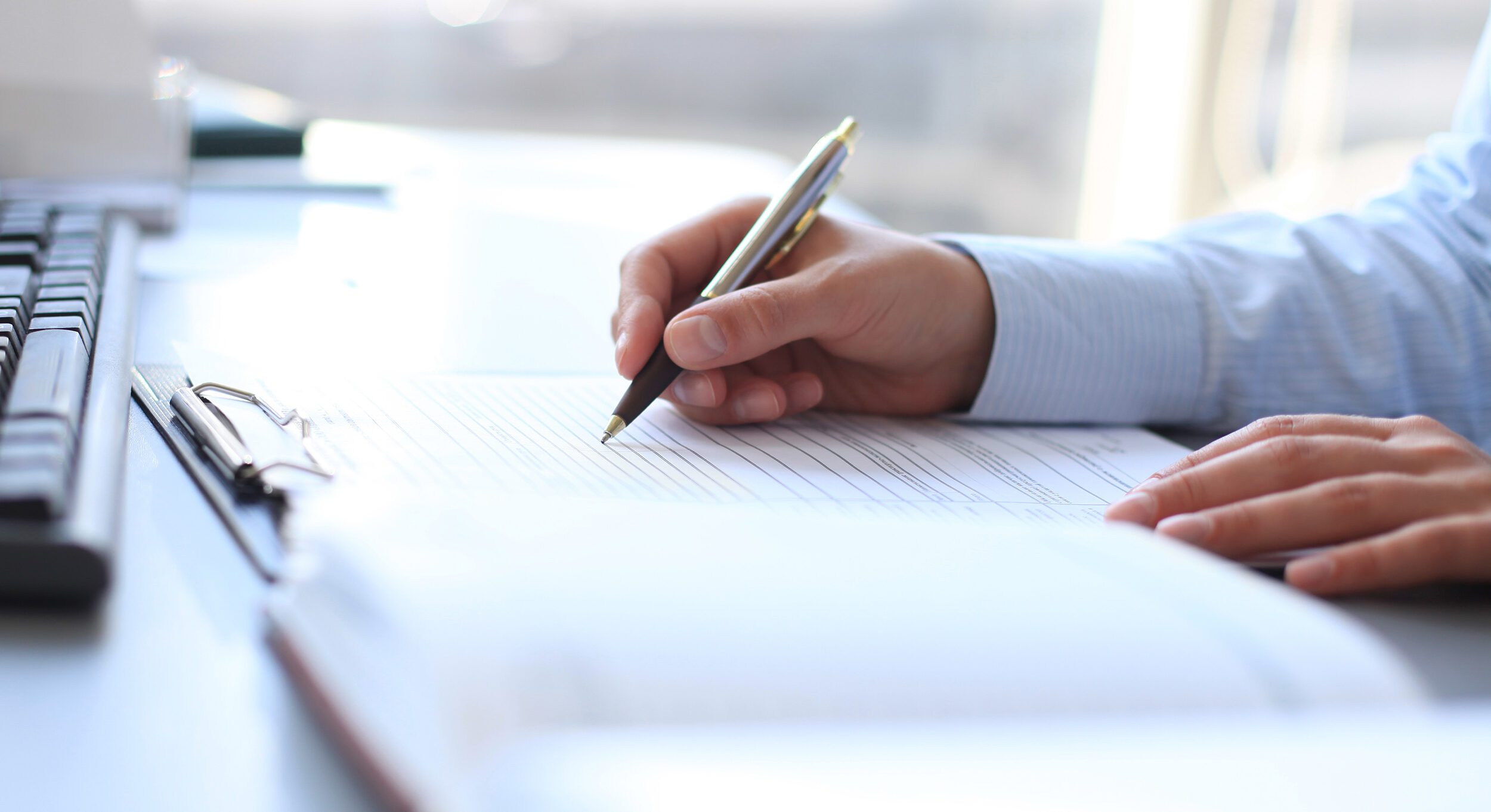 A person sitting at a desk doing paperwork.